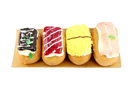 Donuts sort in the  bamboo dish on white background 