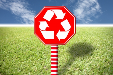 Red label with the symbol of environment on the grass and blue sky,This concept shows how to protect the environment.の写真素材