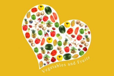 Vegetables and fruits on a white heart,It reflects the care and love to eat good food の写真素材