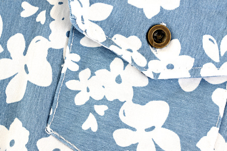 White flower pattern on blue fabric pocket for the background.  