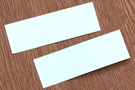 Rectangle of note paper stuck on dark wood pattern background.の写真素材