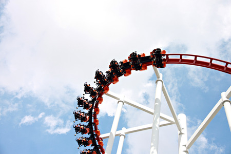 Rollercoaster against blue sky in amusement park.の写真素材