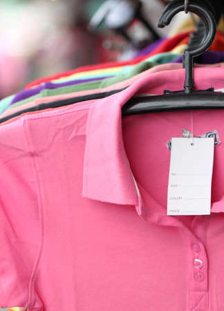 Pink shirt on a hanger in shop.の写真素材