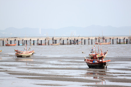 Small fishing boats on the Seashore at low tide.の写真素材
