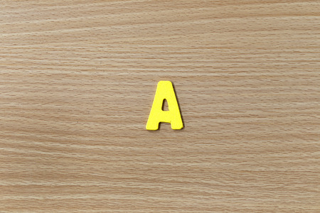 alphabet of English language on wood background.