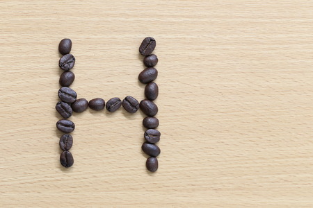 Coffee beans of alphabet placed on the wood .の写真素材