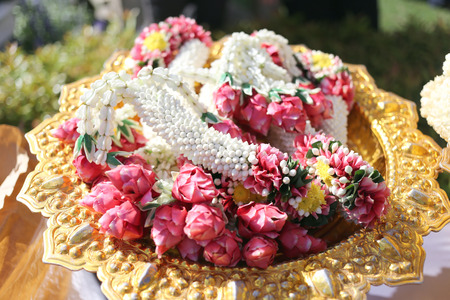 Garland of flowers in utensil for the worship.の写真素材