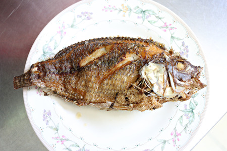Fried fish on a dish in a restaurant.