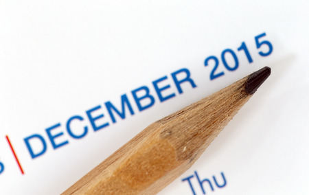 The tip of a pencil point to the year 2015 text on a calendar.の写真素材