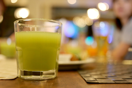 Juice in glass on tableware.