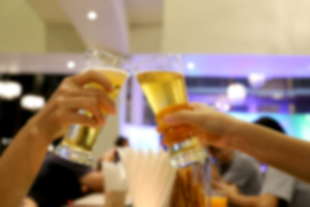 Blur clinking glasses of dinner in a restaurant.の写真素材