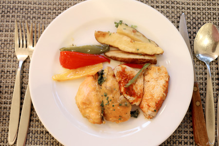 Chicken baked in a white dish.の写真素材