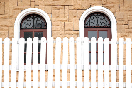 White fences and windows of the house.の写真素材