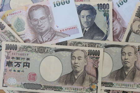 Banknotes of the Japan and Thailand money background.