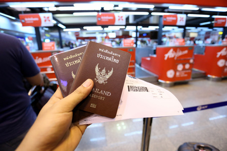 Passport in hand at airport before departure.のeditorial素材