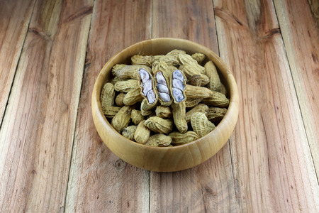 Peanuts in the wooden bowl.