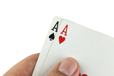Double A playing cards in hand on white background.