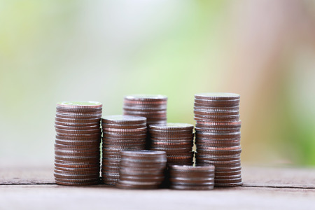 silver coin stack in business growth concept on wood floor with colorful nature background.