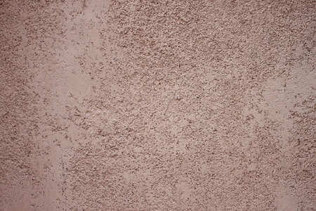 uneven surface of the brown cement wall for design background.の写真素材