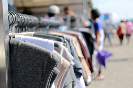 Clothes hanging on the rack in Festival cheap products in Thailand,Thai people and traveler coming to shop in this task.の写真素材