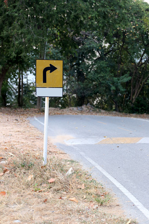 Warning signs for curves road,Street that traverses the mountain.の写真素材