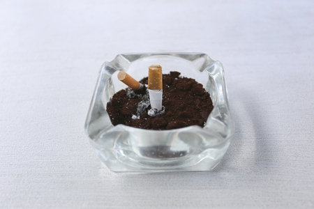 Ashtray on the white table for disposable cigarette after smoking it.の写真素材
