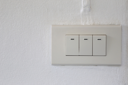 light switch on wall in the house,device plugs for open and close.の写真素材