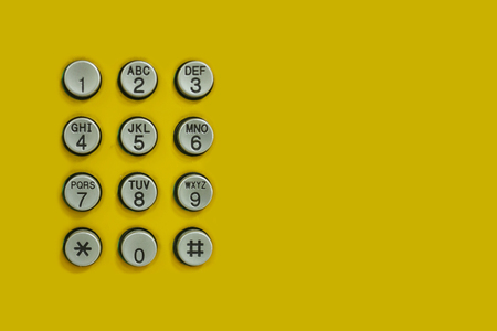 Numeric keypad of phone on the yellow background for the design Technology backdrop.の写真素材