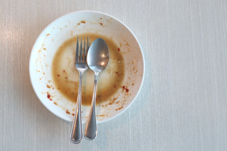 White dish have dirty after put a food and finished eating on table in the restaurant.の写真素材