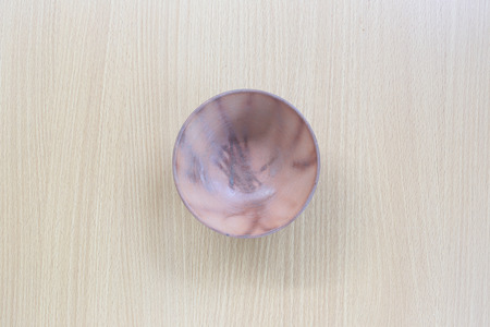 Brown cup in top view on wood background for design concept food.の写真素材