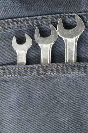 Front pocket of jeans and have wrench in pocket for design Fashion background.の写真素材