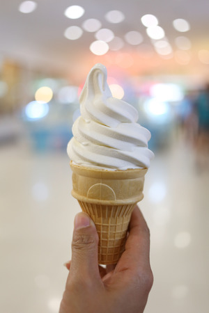 milk ice cream in hand and have bokeh light background.の写真素材