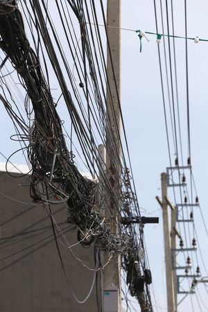 Messy cable electricity post due to poor planning on installing the cable system.の写真素材