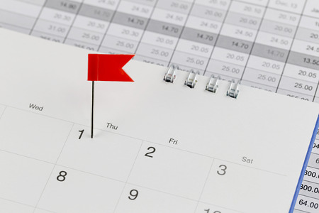 Red Pins to Wildcats on the calendar beside the number of one in business concept time and date.の写真素材