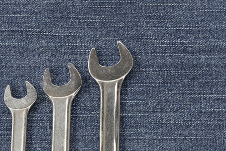 fabric pattern texture of denim or blue jeans and have wrench for the design abstract background.の写真素材