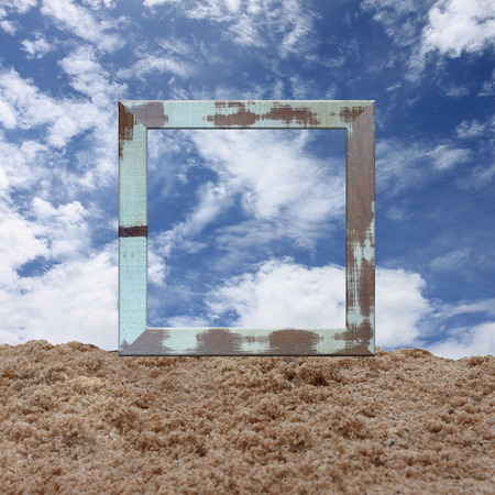 wood frame on sand and have blue sky background.