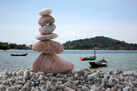 Balance stone on pile rock with sea background for concept of Zen and calm.の写真素材