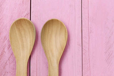 Wooden spoon on pink wood floors,concept of utensils and cooking.の写真素材