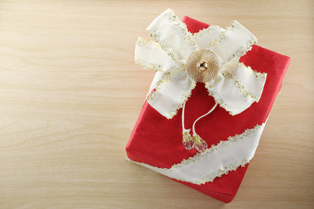Gift box is placed on wooden floor in concept of Christmas and New Year.の写真素材