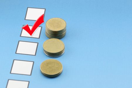 bar graph of Gold coins on blue paper documents and Red check mark on checkbox ,concept of...