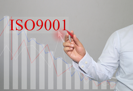 Hand of businessman Write a text of ISO 9001 in concept of presenting ideas in your business.の写真素材