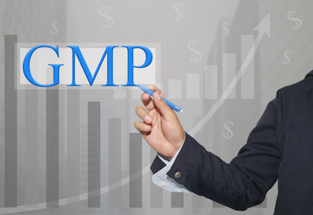 Hand of businessman Write a text of GMP in concept of presenting ideas in your business.の写真素材