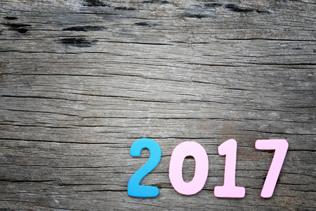 Number two thousand seven of wooden text on brown old wood floor in concept of the New Year 2017.