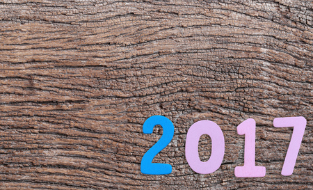 Number two thousand seven of wooden text on brown old wood floor in concept of the New Year 2017.