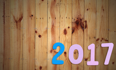Number two thousand seven of wooden text on brown old wood floor in concept of the New Year 2017.