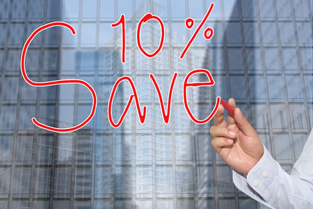 Hand of a businessman hand drawn a word of Save 10% concept of presenting and applying to your...