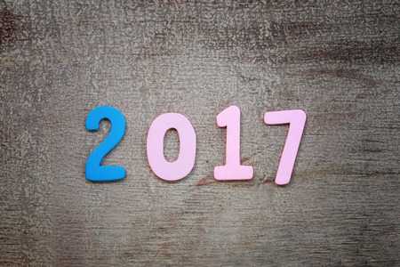 Number two thousand seven of wooden text on brown old wood floor in concept of the New Year 2017.