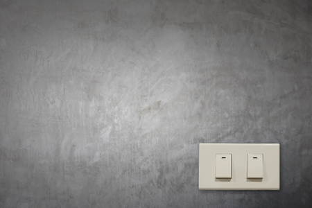 White electric switch on cement wall and have copy space to input your text.