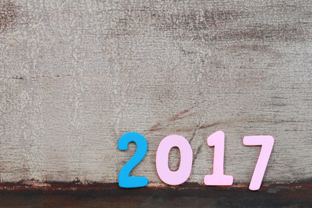 Number two thousand seven of wooden text on brown old wood floor in concept of the New Year 2017.