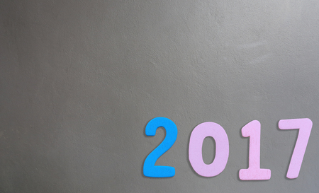 Number of 2017 on a gray cement background in concept of the New Year.